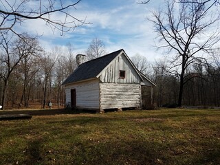 Fototapeta na wymiar old white log cabin house and grass