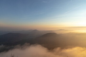 Autumn sunset above foggy hills