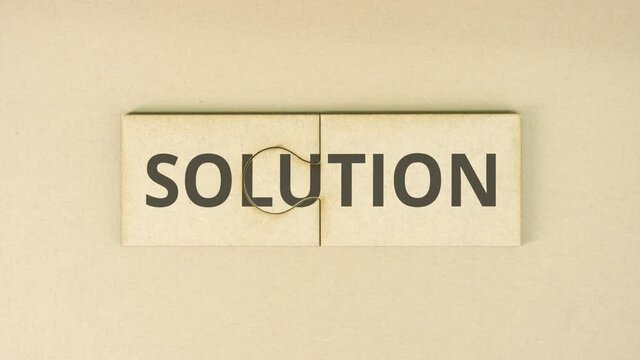 SOLUTION text on cardboard jigsaw puzzle pieces