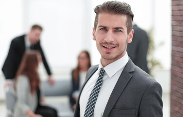 Young man in business suit smiling