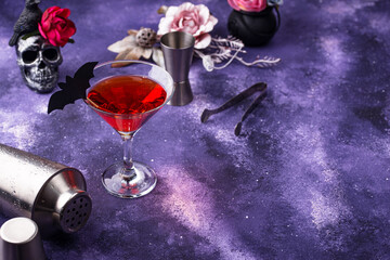 Halloween martini cocktail on purple background