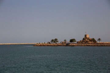 Seascape with watchtower on Quriyat beach, Oman