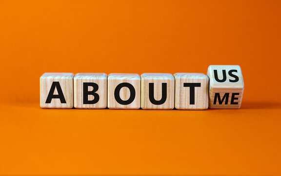 Turned a cube and changed the expression 'about me' to 'about us'. Beautiful orange background. Business concept. Copy space.