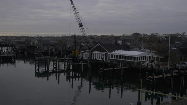 Ferry Leaving Nantucket Island Harbor on gray cloudy day with heavy stormy clouds, deck view