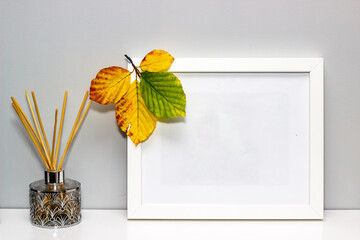 Autumn leaves on the white picture frame 