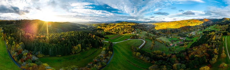 A drone rises above a multi-colored valley in the Vosges. Panoramic view.