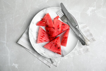 Yummy watermelon slices on grey table, top view