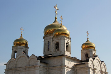 Golden domes of the Orthodox Church against the blue sky.