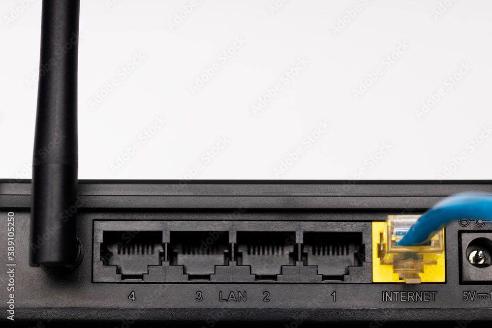 Poster close up internet plug at back side of a wifi router device. internet access hardware