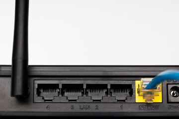 close up internet plug at back side of a wifi router device. internet access hardware
