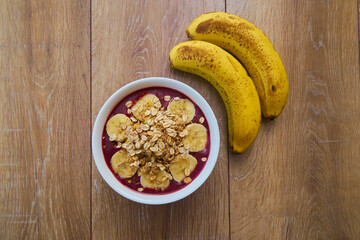 Top view of Brazilian açaí Bowl with bananas and Granola