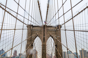 Fototapeta premium Low Angle View of Brooklyn Bridge Top on a Rainy Day in New York City, NY, USA