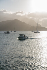 Fototapeta premium boat on the sea during sunset with the vibrant sky during cloudy weather