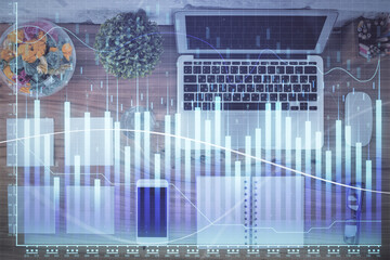 Stock market graph and top view computer on the table background. Multi exposure. Concept of financial education.