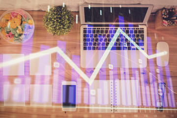 Stock market graph and top view computer on the table background. Multi exposure. Concept of financial education.