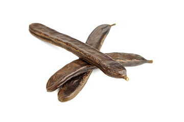 Dry carob fruit pods isolated on white background.