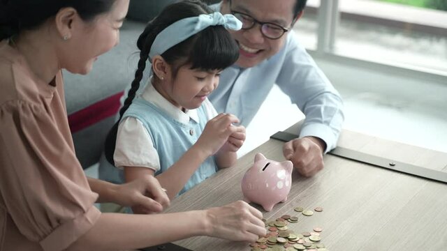 Parents are teaching their daughters to put money in a piggy bank, family with money saving ideas