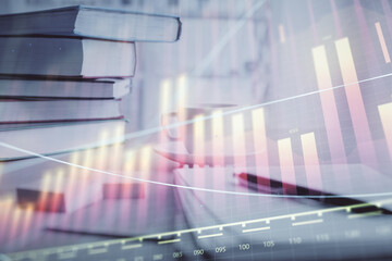 Double exposure of financial chart drawing and desktop with coffee and items on table background....