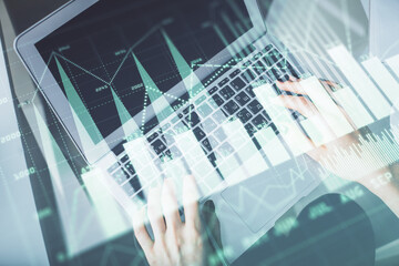 Double exposure of woman hands working on computer and forex chart hologram drawing. Top View. Financial analysis concept.