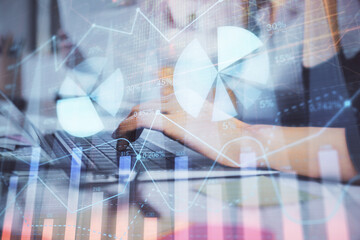 Multi exposure of woman hands typing on computer and financial graph hologram drawing. Stock market analysis concept.