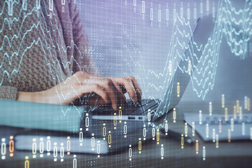 Double exposure of woman hands typing on computer and forex chart hologram drawing. Stock market analysis concept.