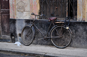 Fototapeta na wymiar Old bicycle chained in a window
