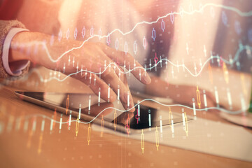 Double exposure of forex graph drawing and man and woman working together holding and using a mobile device. Trade concept.