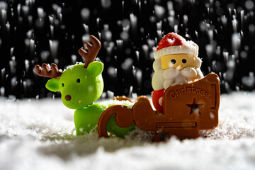 santa claus and reindeer at a snowing night