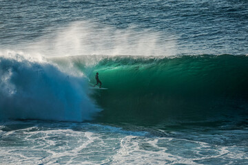 Surfer on perfect blue wave, in the barrel, clean water, Indian Ocean .