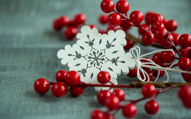 Christmas decorations red berries on a wooden background