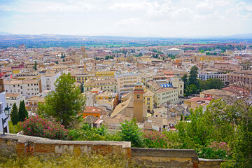 Panoramic view from the city evevated point on old town of Granada and mountains on horizon, Spain. Historic and modern buildings in close proximity to each other in urban settings. - 389122010