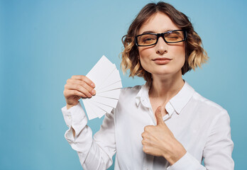 Business woman in shirt with a bundle of business cards in hand mockup