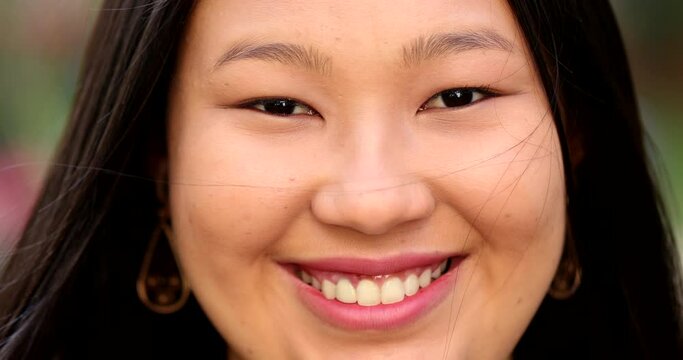 Happy Asian large young woman smiling at camera close-up portrait face
