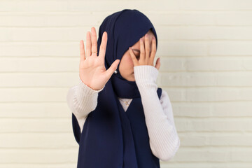 Asian muslim hijab woman show stop hands gesture
