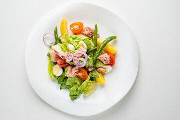 Tuna salad with tomatoes , green beans , eggs and onion