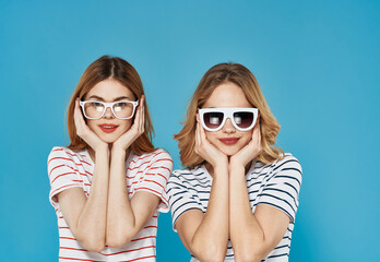 two funny sisters in striped t-shirts with glasses fashion lifestyle communication