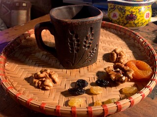 
tea party teapot infuser infuser tea chinese tea tea party tea ceremony ceramics oriental pattern comfort warmth bamboo mat weaving wood yellow clay brown mug ear dried fruit dried apricots raisins w