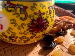 
tea party teapot infuser infuser tea chinese tea tea party tea ceremony ceramics oriental pattern comfort warmth bamboo mat weaving wood yellow clay brown mug ear dried fruit dried apricots raisins w