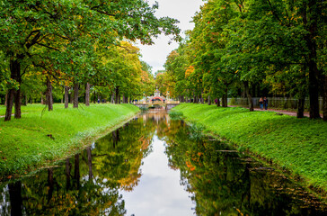 Triple alley in autumn. Bypass channel and small Chinese bridges. Alexander Park. Pushkin. St....
