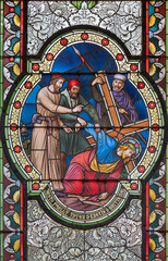 VIENNA, AUSTIRA - OCTOBER 22, 2020: The Fall of Jesus under the cross on the stained glass in church Pfarrkirche Kaisermühlen by workroom Tiroler Glasmalerei-Anstalt from end of 19. cent..