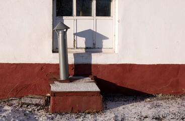 Spassk-Ryazan. The Ryazan region. Russia. January 09.2018. A vent pipe and its shadow on a Sunny winter morning.