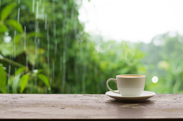 Close up coffee espresso on wood table raining background in garden,