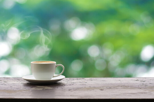 Close up coffee espresso on wood table raining background in garden,