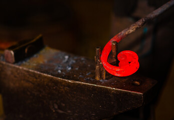 The blacksmith twists the spiral with the help of an anvil, heating the iron blank to red. Work in...