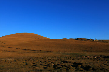 Fototapeta na wymiar Hills under blue sky in Keshiketeng World Geopark, Inner Mongolia
