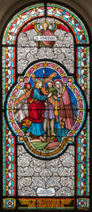 VIENNA, AUSTIRA - OCTOBER 22, 2020: The  Jesus meet his Mother Mary scene on the stained glass in  in church Pfarrkirche Kaisermühlen by  workroom Tiroler Glasmalerei-Anstalt from end of 19. cent..