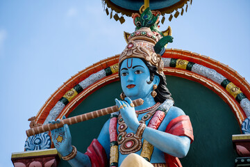 Detail stone statue in Sri Krishnan temple on south indian hindu temple in Singapore on blue sky background - obrazy, fototapety, plakaty