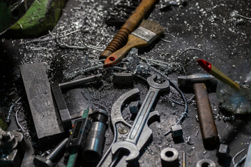 set of tools covered with aluminium metal swarf on machinery worker table
