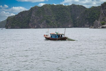 Fishermen at work on their boat in Halong Bay in Vietnam