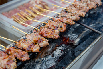 Grilled pork in skewers in the market.